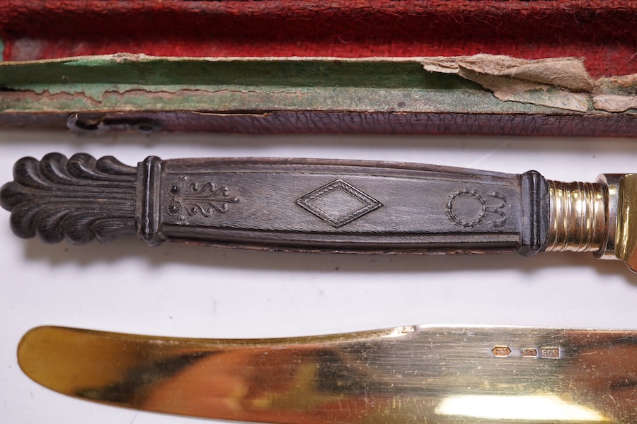 An early to mid 20th century Austrian boxed set of six carved wood handled 800 standard gilt white metal dessert knives, 20.7cm. Condition - poor to fair